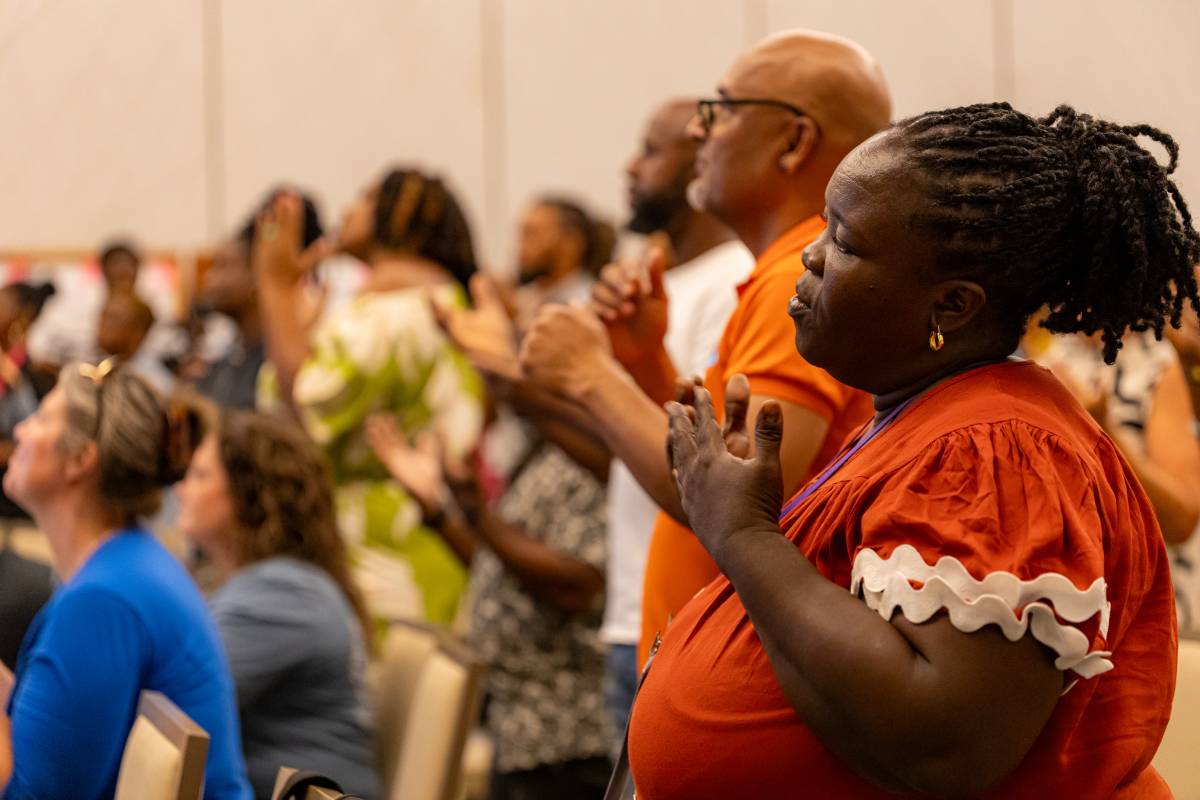 People worshipping and praying at the sign language Bible conference in Barbados.